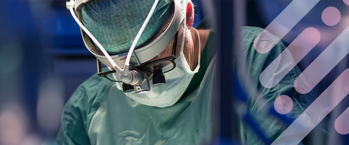 A peripheral nerve surgeon wearing loupes and PPE performs a nerve repair procedure