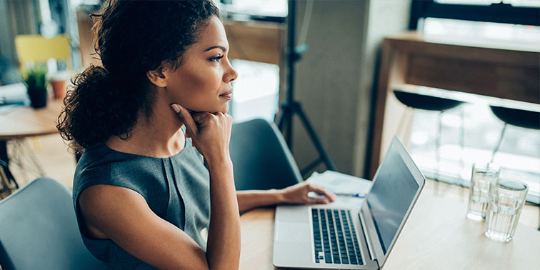 A woman researches breast reconstruction options on a laptop