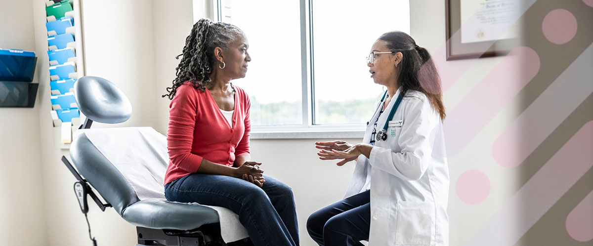 A surgeon consults with a woman about her mastectomy treatment plan